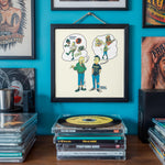 Lade das Bild in den Galerie-Viewer, a wall with a framed cartoon illustration of two people, one with a guitar and the other with a skateboard, surrounded by various CDs and records.
