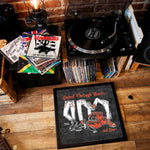 Lade das Bild in den Galerie-Viewer, a collection of vinyl records and a turntable, along with a framed poster or artwork that reads "United Through Music... and Beer".
