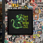 Load image into Gallery viewer, The image is a wall covered in a collage of various stickers, posters, and graffiti, creating a visually busy and chaotic appearance.
