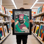 Load image into Gallery viewer, A person is holding up a framed poster of a woman with pink hair and a black and white checkered pattern, which appears to be a comic book cover.
