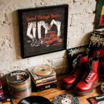 Lade das Bild in den Galerie-Viewer, a collection of music-related items, including a framed poster, CDs, and boots, all arranged on a wooden surface.
