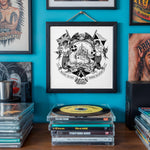 Load image into Gallery viewer, a wall with a framed artwork depicting a mermaid and a ship, surrounded by various framed artworks and photographs. In front of the artwork, there is a stack of CD cases and a collection of vinyl records.
