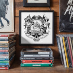 Load image into Gallery viewer, a collection of various items, including a framed artwork, a stack of CDs, and a collection of books, all displayed on a wooden surface.

