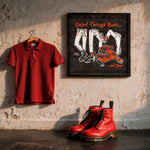 Lade das Bild in den Galerie-Viewer, a red polo shirt hanging on a wall, a pair of red boots, and a framed poster with illustrations of jeans and shoes.
