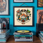Lade das Bild in den Galerie-Viewer, a wall adorned with various framed pictures and a framed artwork depicting a mermaid and a ship, surrounded by a vibrant design. In front of the artwork, there is a stack of CD cases, suggesting a collection of music or other audio materials.
