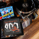 Lade das Bild in den Galerie-Viewer, a collection of music-related items, including a turntable, a framed poster, and a stack of CDs.
